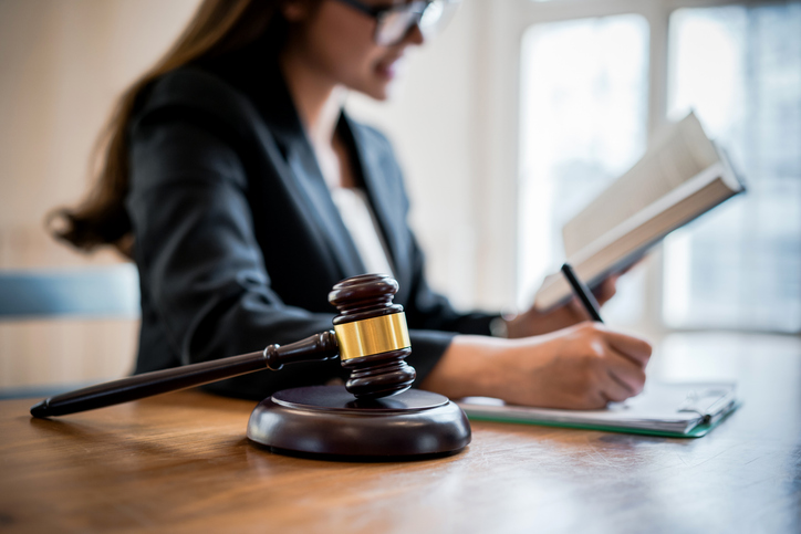 Lawyer business women consultant reading and writing on a note in office. Law, legal services, advice, consult, Justice concept.